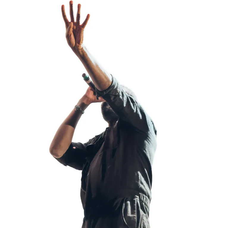 A singer mid performance, arm raised, lost in the moment.